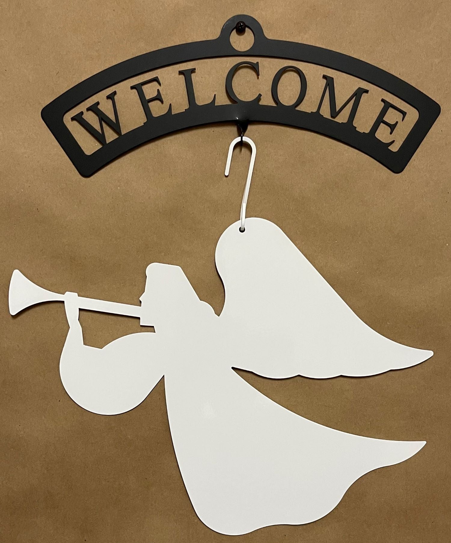 Welcome sign with white angel silhouette hanging