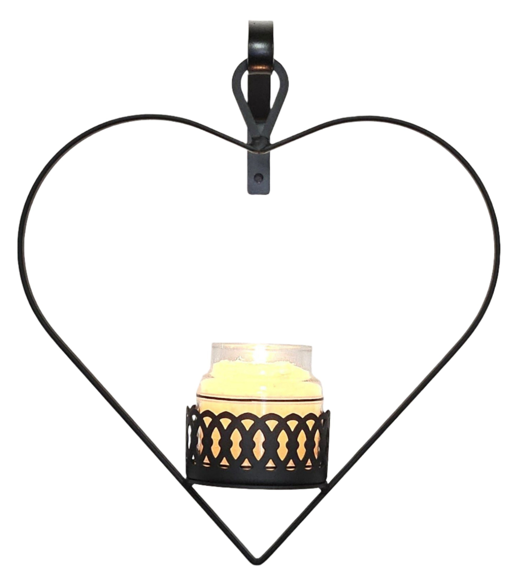 Heart-shaped metal candle holder with lit candle