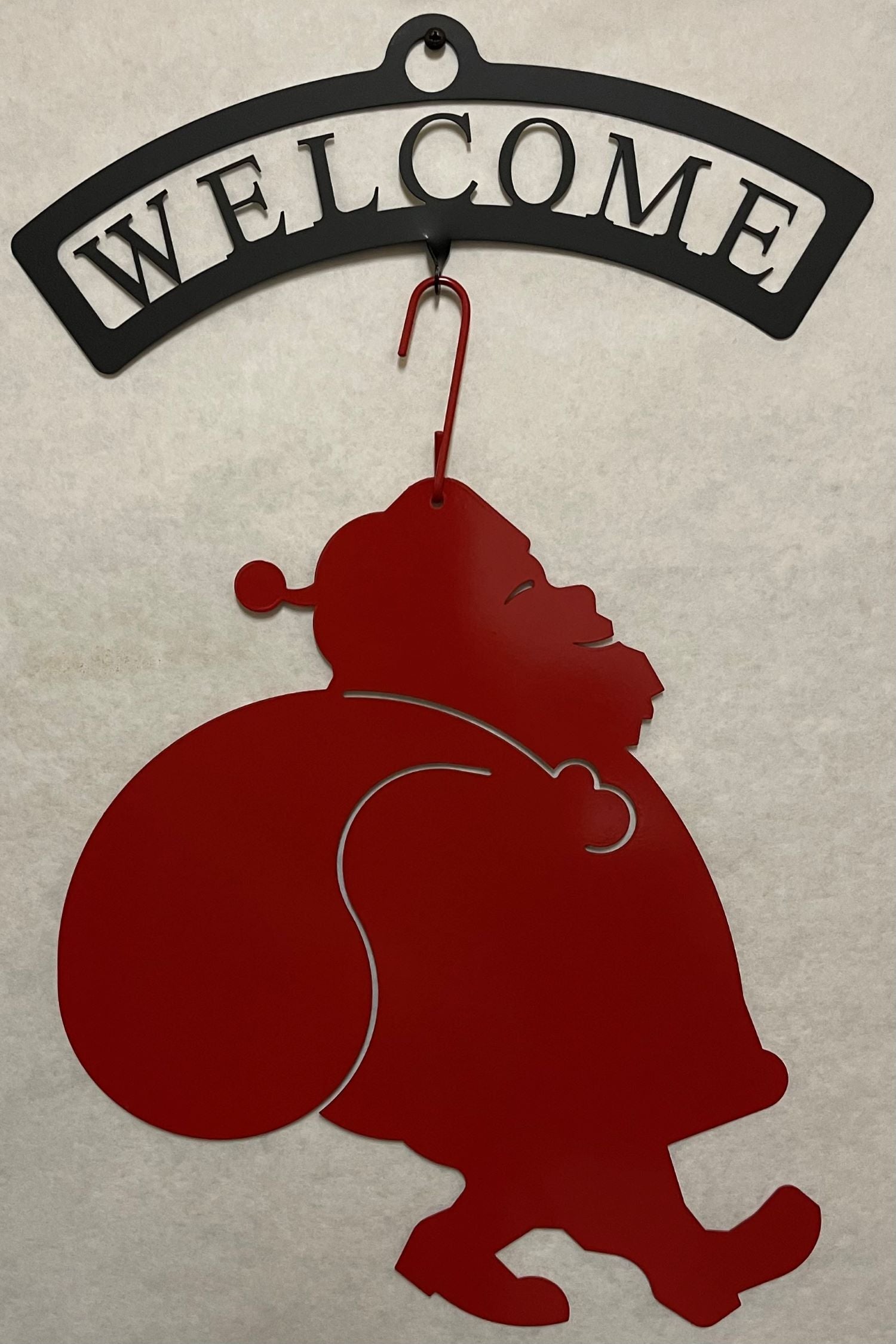 Wrought iron welcome sign with red Santa silhouette