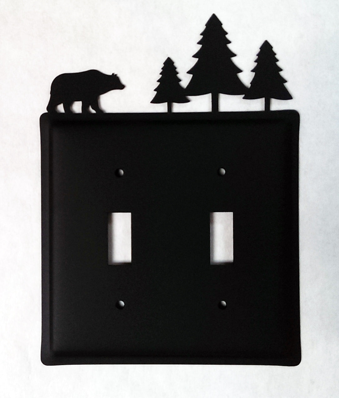 Wrought iron switch cover with bear and pine trees design