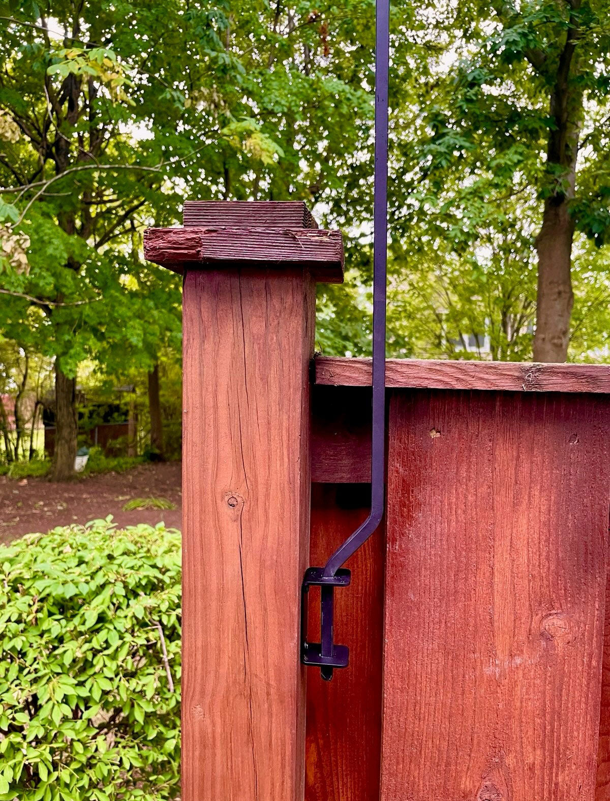 Close-up of lawn hook mounted on deck railing