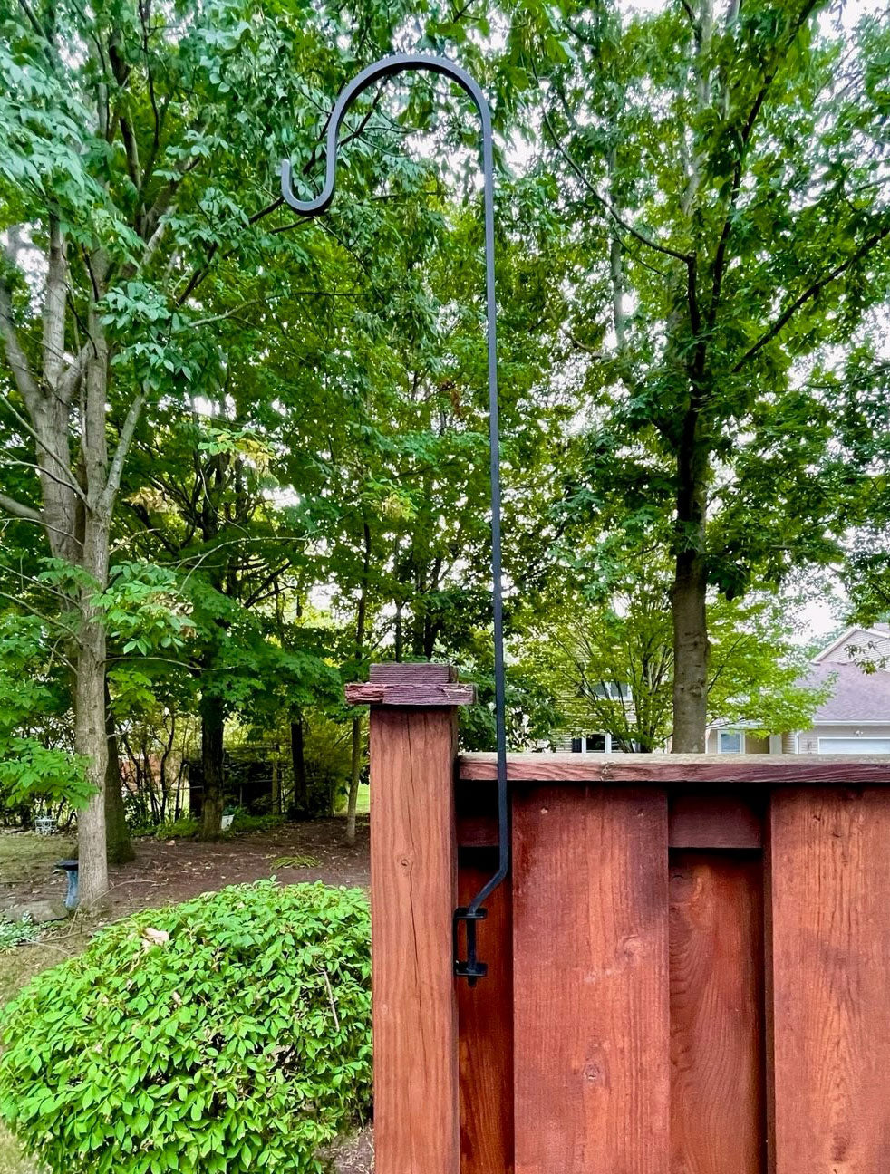 Deck mounting lawn hook installed on wooden railing