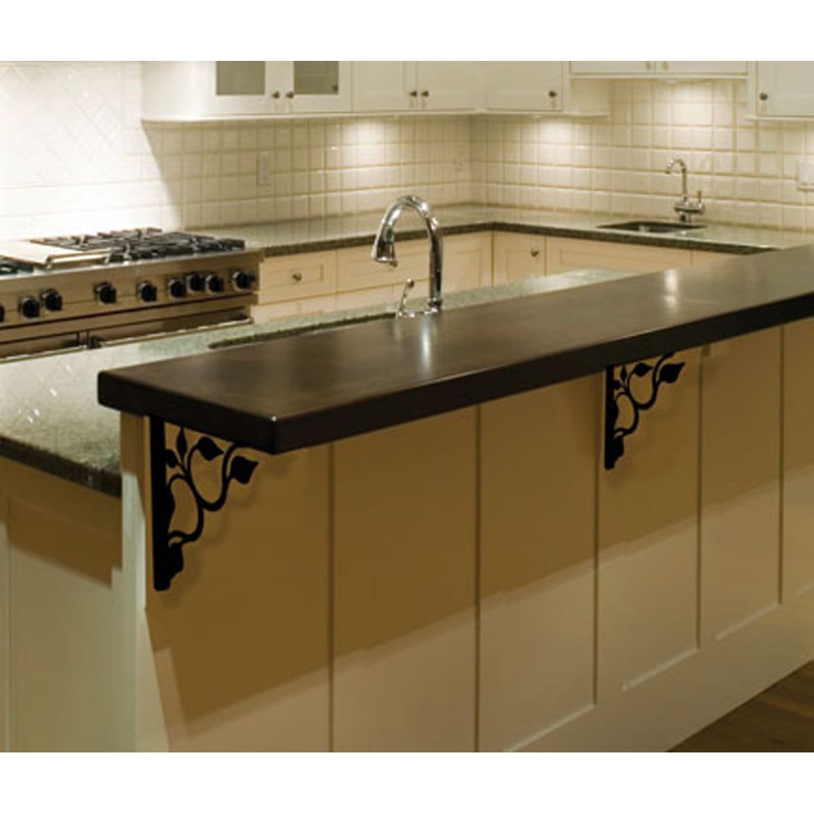 Kitchen counter supported by wrought iron ribbon shelf brackets.