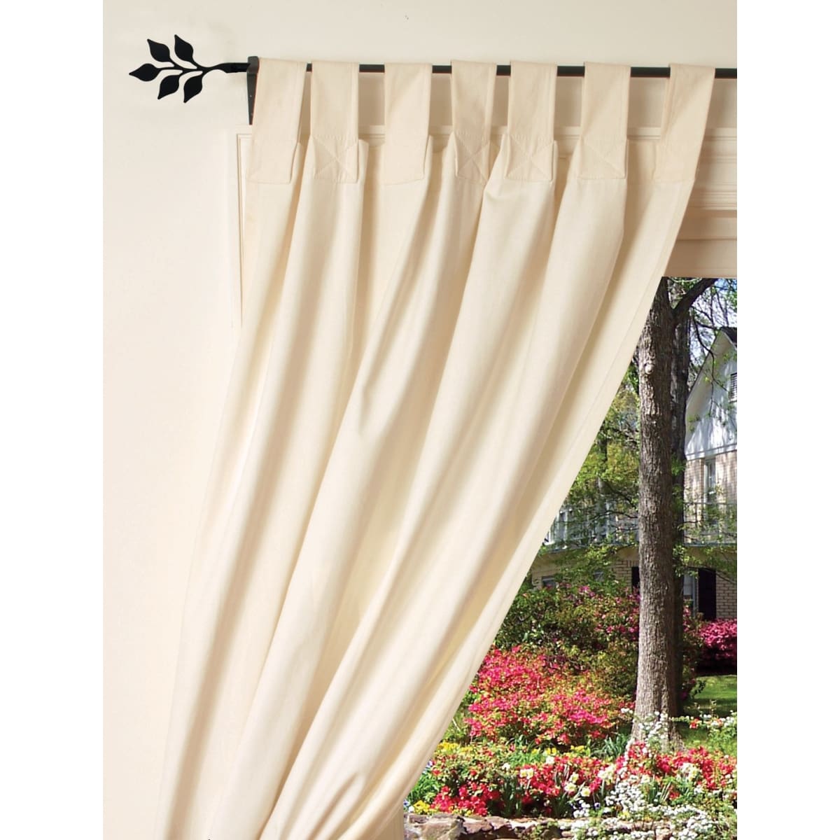 Curtain rod with cream curtains and garden view